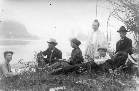 Print from large post card negative.  GWI Jones and Family. Unusual picture. L to R: George, CV, Raye (with gun) LaDora, Robert, GWI and Pha. Location unknown.